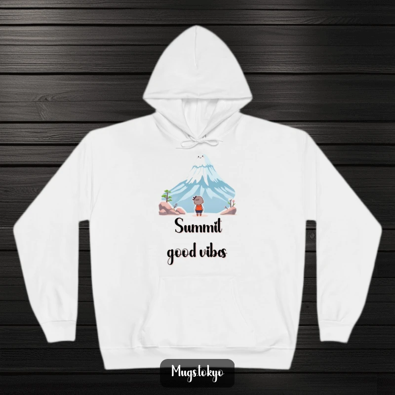 Funny hoodie with a character looking up in awe at a whimsical, smiling Mount Fuji, offering warmth and humor.