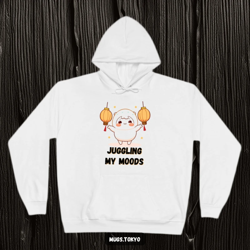 A warm hoodie featuring a funny cheerful mochi character with rosy cheeks juggling glowing lanterns.