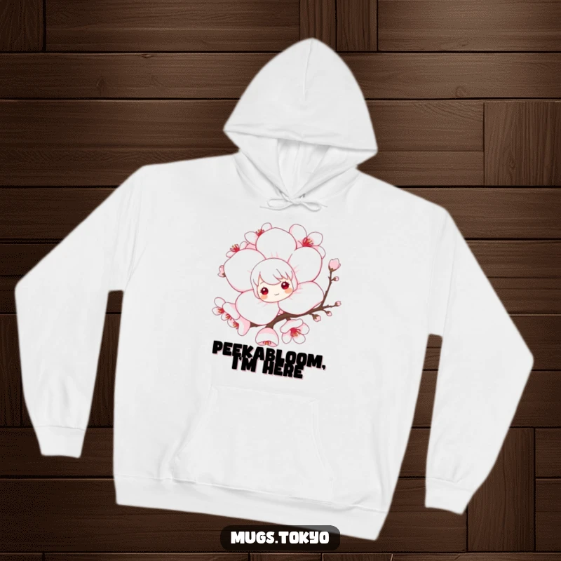 Funny hoodie with a playful character peeking from behind a large, elegant cherry blossom, offering cozy warmth and whimsical delight.